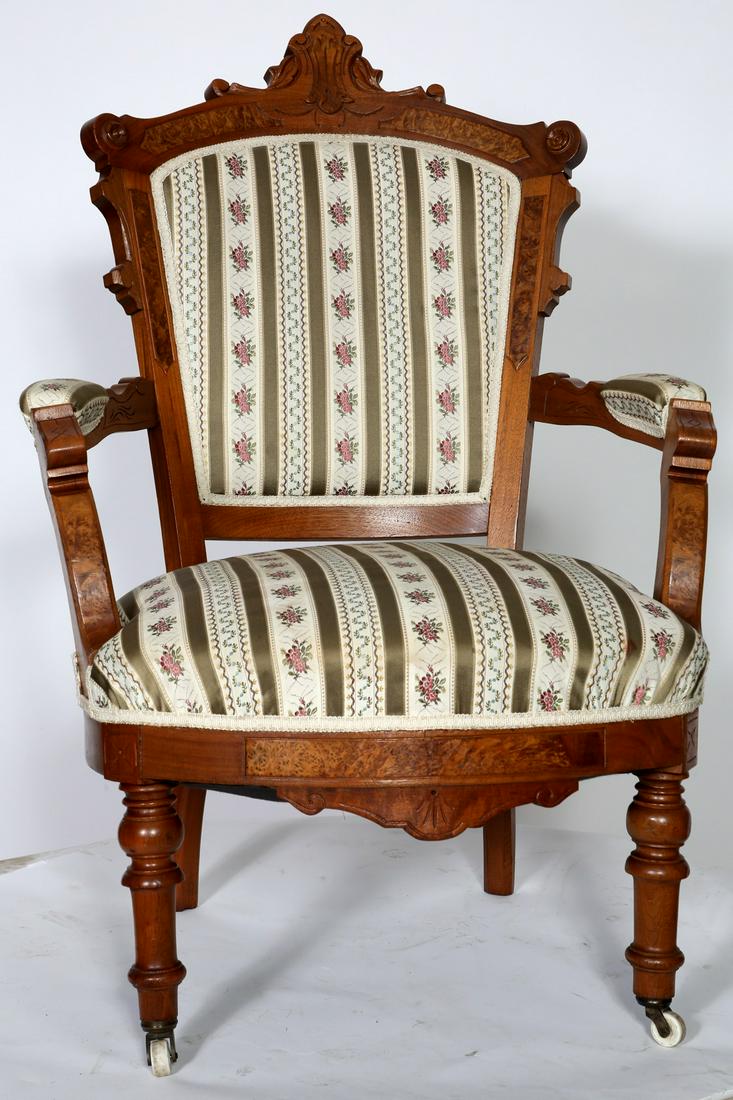 Walnut Victorian Renaissance Arm Chair: Walnut Victorian Renaissance Arm Chair,carved, burled trim, turned legs,porcelain casters. Condition: Good, refinished. Size: 28" W x 23 1/2" D x 39 1/2" H