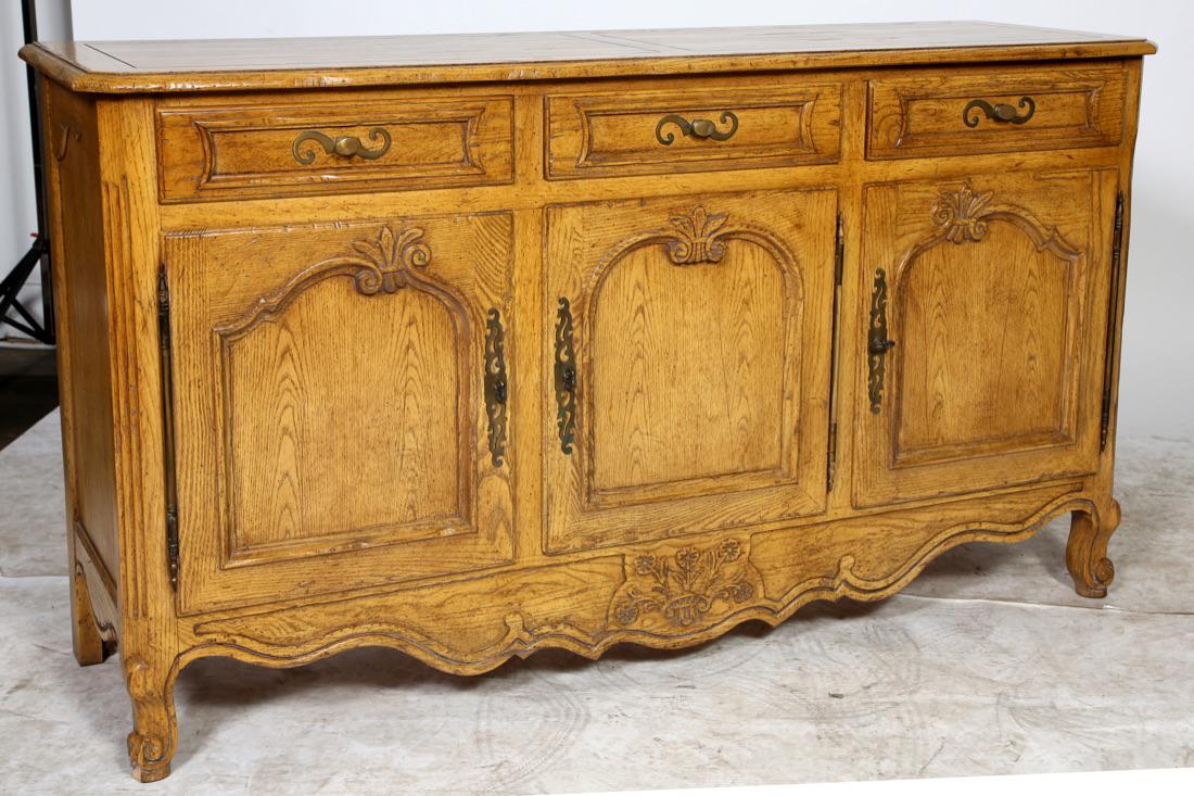 Baker Furniture French Provincial Sideboard: Baker Furniture French Provincial Sideboard. Signed w/Baker Oval Tag Condition: Good, minor wood loss to lower left front foot. Normal wear and scratches. Size: 62" W x 19" D x 34 3/4" H