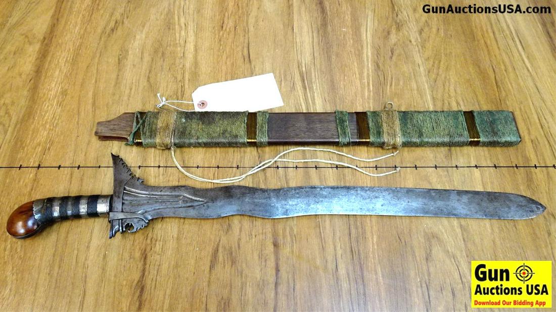 MORO Sword. Very Good. This Moro Blade is in Kris: MORO Sword. Very Good. This Moro Blade is in Kris Configuration. Extremely Sharp, Smooth Sided with a Serpentine Blade. The Handle is Embellished with Engraved Steel and Tard Cloth. Blade Guard is Orn