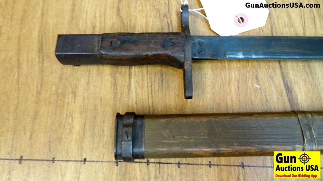 Japanese 38 Bayonet. Very Good. Wooden Scales On: Japanese 38 Bayonet. Very Good. Wooden Scales On Bayonet, Retainer Spring Loaded Still Working, Wooden Scabbard with Copper Wire Wrap.. (40354)
