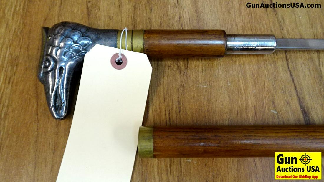. Very Good. 36" Wooden Cane with Eagles Head, When: . Very Good. 36" Wooden Cane with Eagles Head, When Twisted and Extended it Reveals a 24 Inch Blade, Well Balanced and Hidden within the Wooden Handle. The Handle Appears to be Steel Eagles Head. Coll