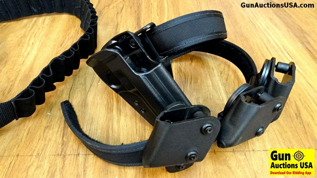 Schoate, Safari Land Speed Stripper Shotgun Shell: Schoate, Safari Land Speed Stripper Shotgun Shell Holders . Very Good. Lot of 2: One Holster with Mag Carriers and Belt and One Shotgun Shell Carrier with Speed Strippers. . (43004)