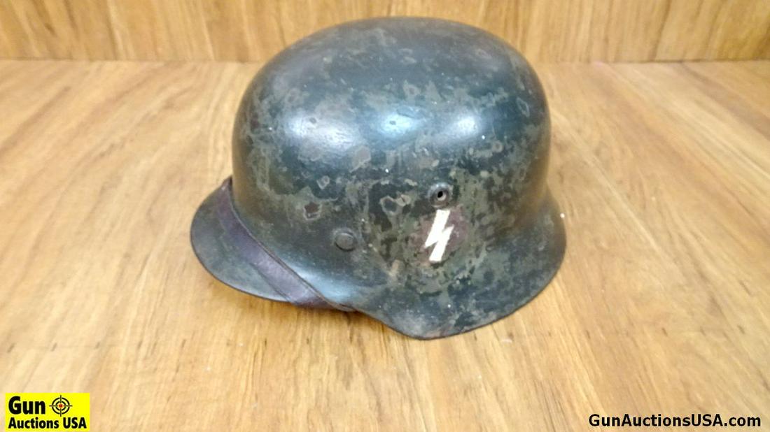 GERMAN MILITARY M35 WWII COLLECTOR'S Helmet. Good: GERMAN MILITARY M35 WWII COLLECTOR'S Helmet. Good Condition. Original Chin Strap is On Helmet, Leather Liner, Exterior Helmet is Dark Green with Some Chips. 2812 is Stamped Inside Helmet, Decals have 
