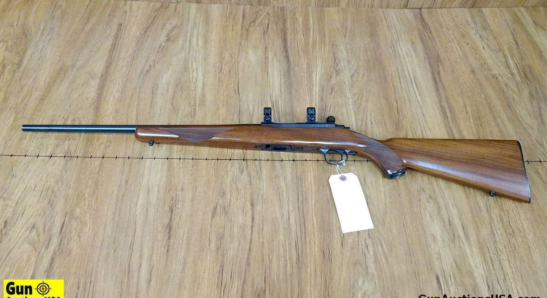 Ruger 77/22 .22 LR Rifle. Very Good. 20" Barrel. Shiny: Ruger 77/22 .22 LR Rifle. Very Good. 20" Barrel. Shiny Bore, Tight Action Ready For Scope, Rings are Attached. Mauser Style Bolt Action, Minor Handling Marks on a Beautiful Walnut Checkered Stock. Loc