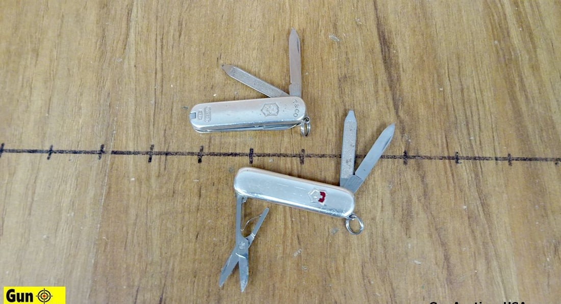 Tiffany, Victorinox Sterling Knives. Good Condition . Lot of 2; #1 - Tiffany Knife, T & CO. Stamped: Tiffany, Victorinox Sterling Knives. Good Condition . Lot of 2; #1 - Tiffany Knife, T & CO. Stamped on Knife. 925 Sterling Silver, Shield with Cross Emblem inside, with Oval Circle 1837 Stamped. #2- V