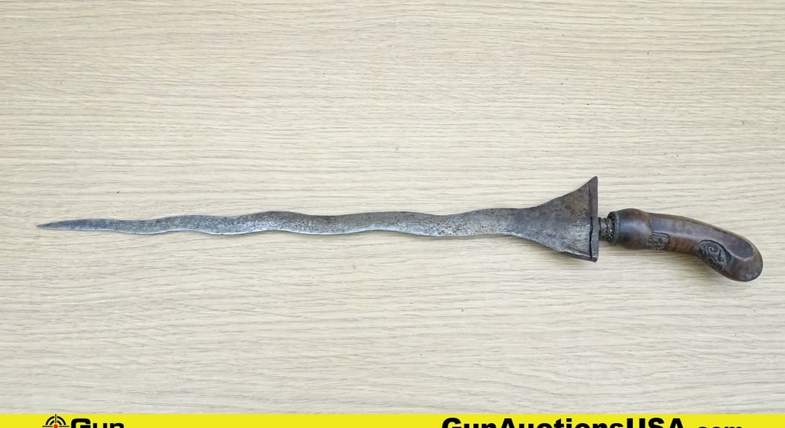 Dagger. Good. Antique Malaysian Kris Dagger w/Conditioned Rawhide Handguard and Ornate Handle.: Dagger. Good. Antique Malaysian Kris Dagger w/Conditioned Rawhide Handguard and Ornate Handle. Includes Ornate Scabbard and features a 13.5 " Blade Length, 19 " Overall Length.. (68089)