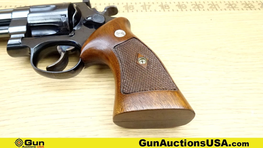 S&W 1955 .45 AUTO Revolver. Good Condition. 6.5" Barrel. Shiny Bore, Tight Action Case Hardened: S&W 1955 .45 AUTO Revolver. Good Condition. 6.5" Barrel. Shiny Bore, Tight Action Case Hardened Hammer and Trigger, with a 6 Shot Fluted Cylinder. Brown Wood Checkered Grips with S&W Medallions. DA/SA