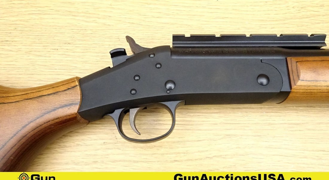 H&R 1871 12 ga. Shotgun. Very Good. 24" Barrel. Shiny Bore, Tight Action Break Action Features a: H&R 1871 12 ga. Shotgun. Very Good. 24" Barrel. Shiny Bore, Tight Action Break Action Features a Weaver Rail Mounted on Barrel, BEAUTIFUL Laminated Furniture, Rubber Re-Coil Pad, with Sling Swivel Stu