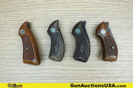 Grips. Good Condition. Four Sets of S&W Wood Checkered Grips, Patina, with Medallions. . (77676)