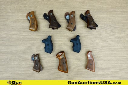 S&W Grips . Good Condition. Nine Sets of Assorted S&W Grips, Wood and Rubber. . (78385) (GSCM77)