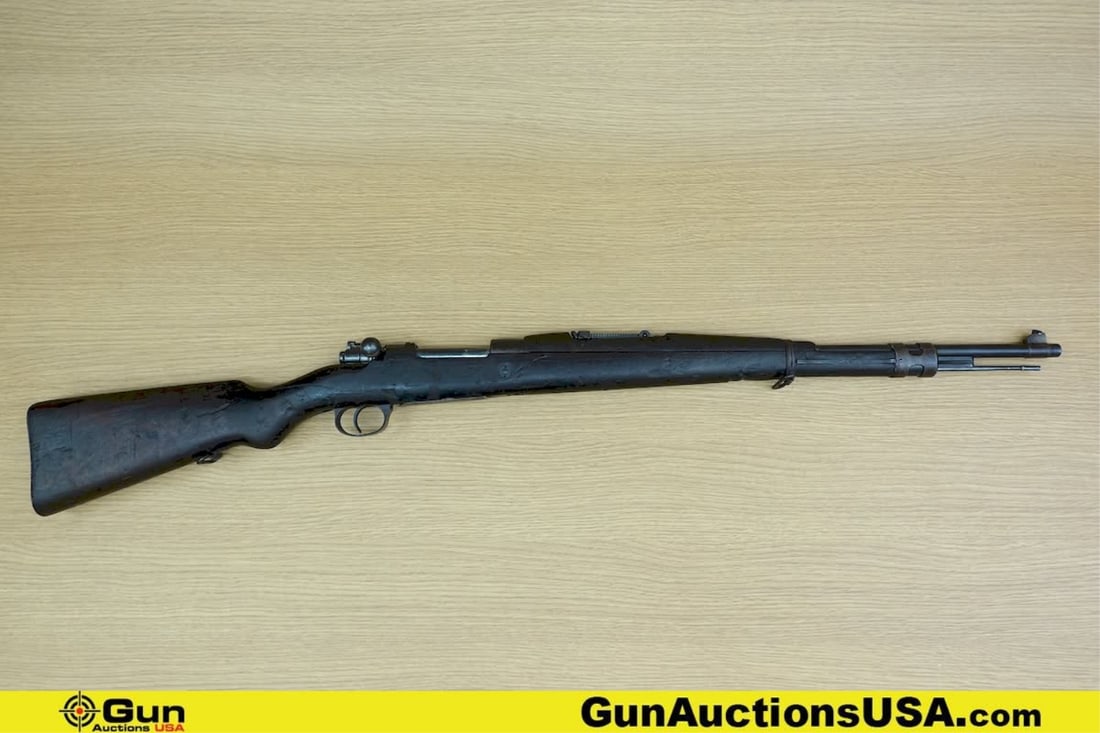 FNH M1924 7MM MAUSER Venezuelan 98K Rifle. Good condition, Normal Handling Marks, Scattered Spotting: FNH M1924 7MM MAUSER Venezuelan 98K Rifle. Good condition, Normal Handling Marks, Scattered Spotting and/or Pitting. 23.5" Barrel. Shiny Bore, Tight Action Bolt Action Features a Barley Corn Drift Adj