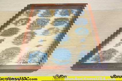 Harley Davidson Antiques. Very Good. Sixteen Assorted Antique Buckles and Pins in Display Frame..