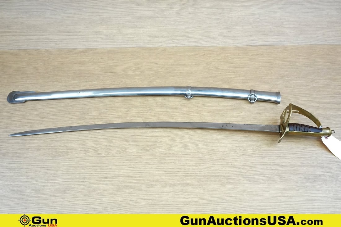 Replica Saber. Very Good. One Replica Cavalry Saber with a Brass hand Guard, Wood Handle, with Metal: Replica Saber. Very Good. One Replica Cavalry Saber with a Brass hand Guard, Wood Handle, with Metal Scabbard. . (81951) (GSCE97)