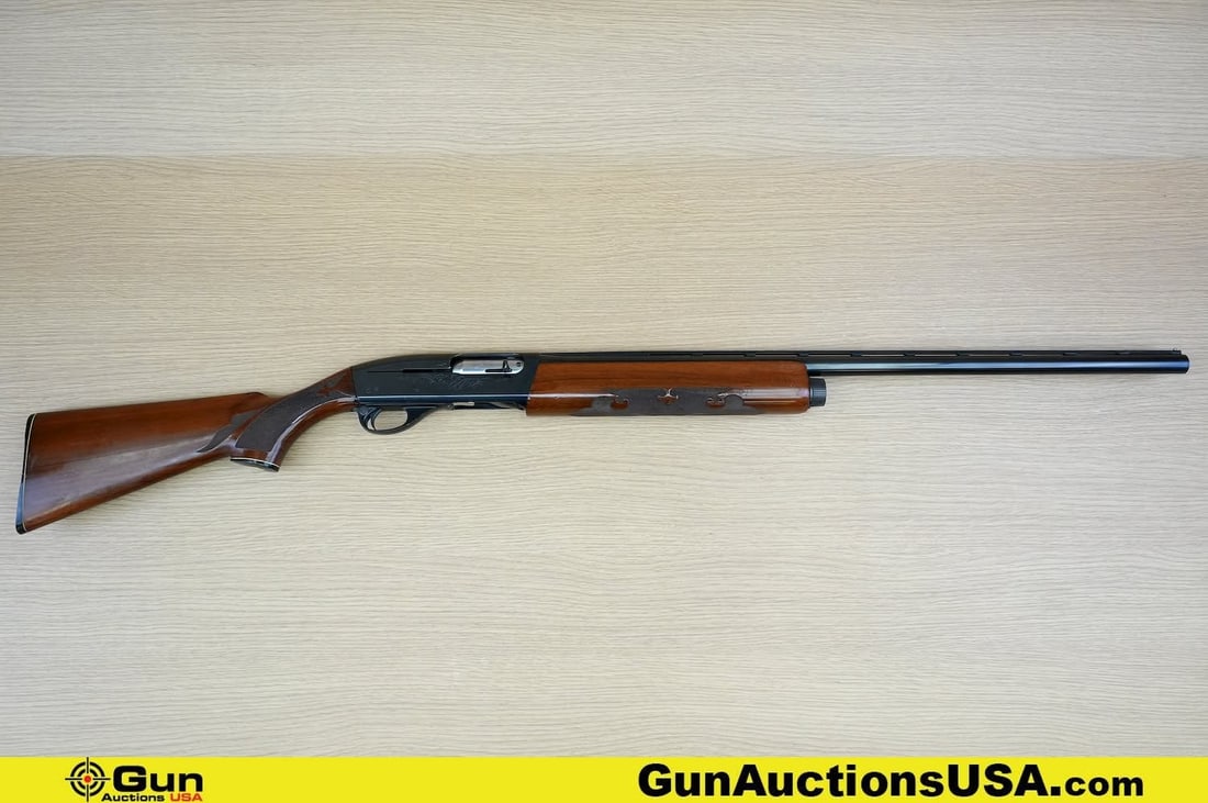 REMINGTON 1100 12 GA. Shotgun. Good Condition, Normal Handling Marks. 27" Barrel. Shiny Bore, Tight: REMINGTON 1100 12 GA. Shotgun. Good Condition, Normal Handling Marks. 27" Barrel. Shiny Bore, Tight Action Semi Auto Features a Checkered Walnut Stock and Hand Guard, Serrated Polymer Butt Plate, Brus