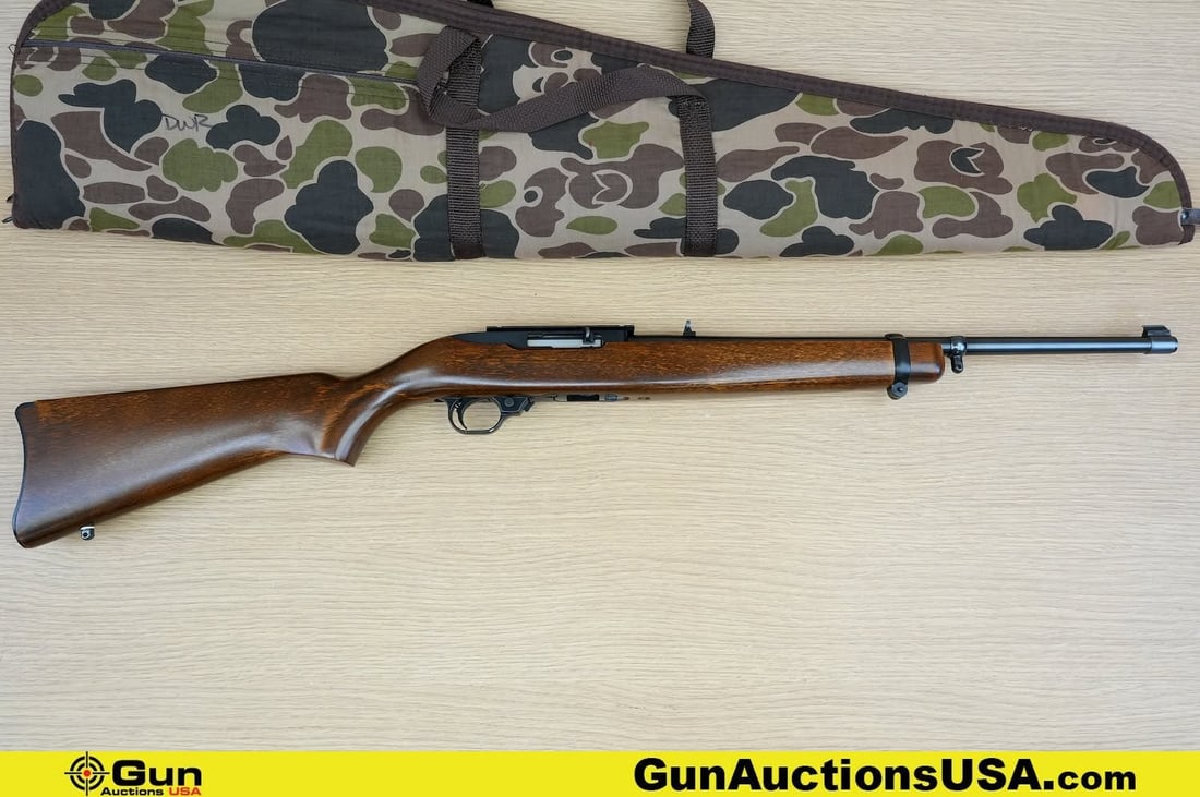 RUGER 10/22 CARBINE .22 LR Rifle. Excellent. 18" Barrel. Shiny Bore, Tight Action Semi Auto.: RUGER 10/22 CARBINE .22 LR Rifle. Excellent. 18" Barrel. Shiny Bore, Tight Action Semi Auto. Features a Full Length Laminate Wood Stock, Top Factory Scope Mount, Flip Up Adjustable Rear Sight, Front B