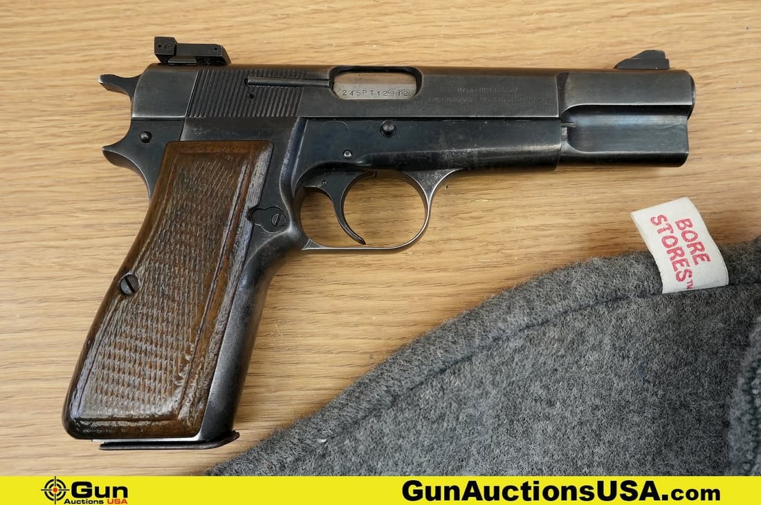 FNH HIGH POWER 9MM LUGER Pistol. Good Condition, Normal Handling Marks. 4.5" Barrel. Shiny Bore,: FNH HIGH POWER 9MM LUGER Pistol. Good Condition, Normal Handling Marks. 4.5" Barrel. Shiny Bore, Tight Action Semi Auto . Features Textured Wood Grips, Fixed Target Style Iron Sights, Left Side Slide 