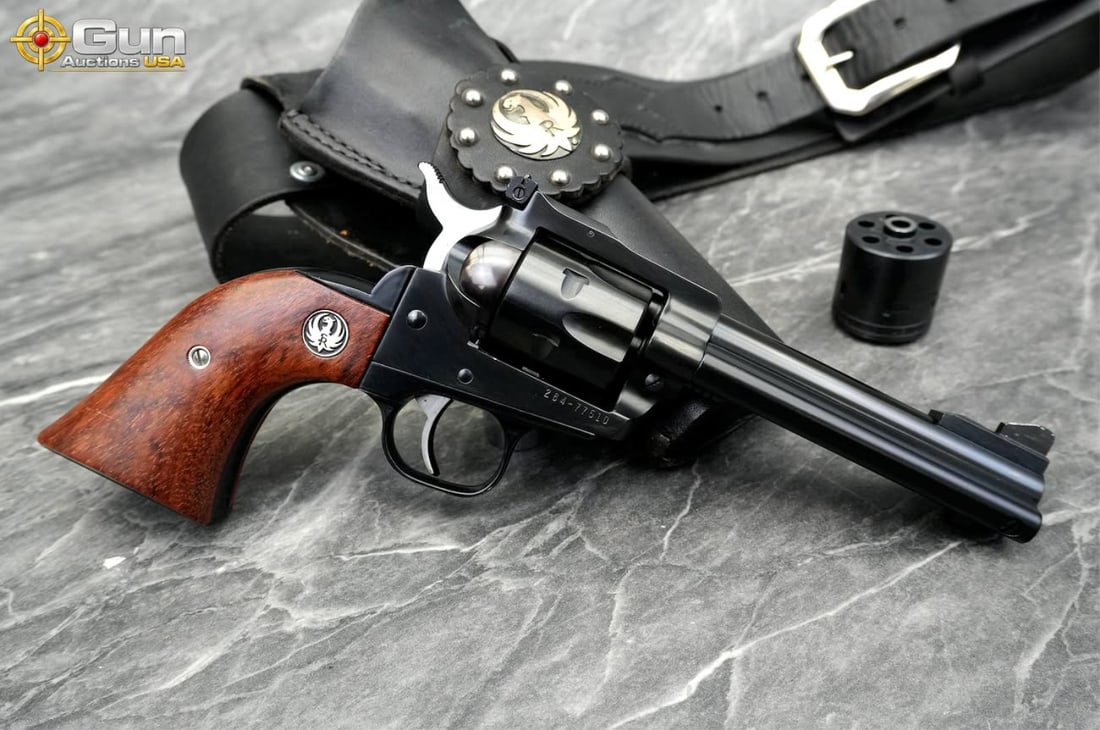 RUGER NEW MODEL SINGLE SIX .22 CAL Revolver, 4.75" Barrel, Very Good Condition, Shiny Bore, Tight: RUGER NEW MODEL SINGLE SIX .22 CAL Revolver, 4.75" Barrel, Very Good Condition, Shiny Bore, Tight Action, sn:264-77510This .22 caliber revolver wears a deep, lustrous blued finish across the frame, si