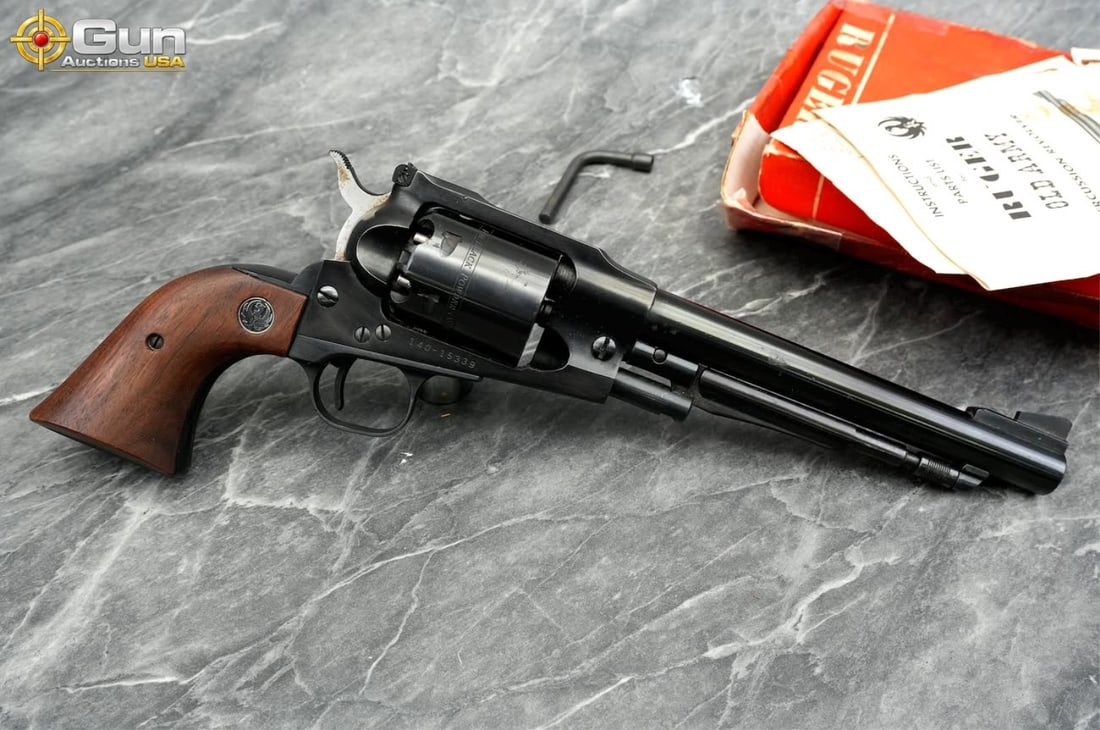 Ruger Old Army .44 Caliber Black Powder Revolver, Good Condition The revolver shows normal handling: Ruger Old Army .44 Caliber Black Powder Revolver, Good ConditionThe revolver shows normal handling marks and slight rust. It features blued finish, walnut grips, and Ruger medallions, along with adjus