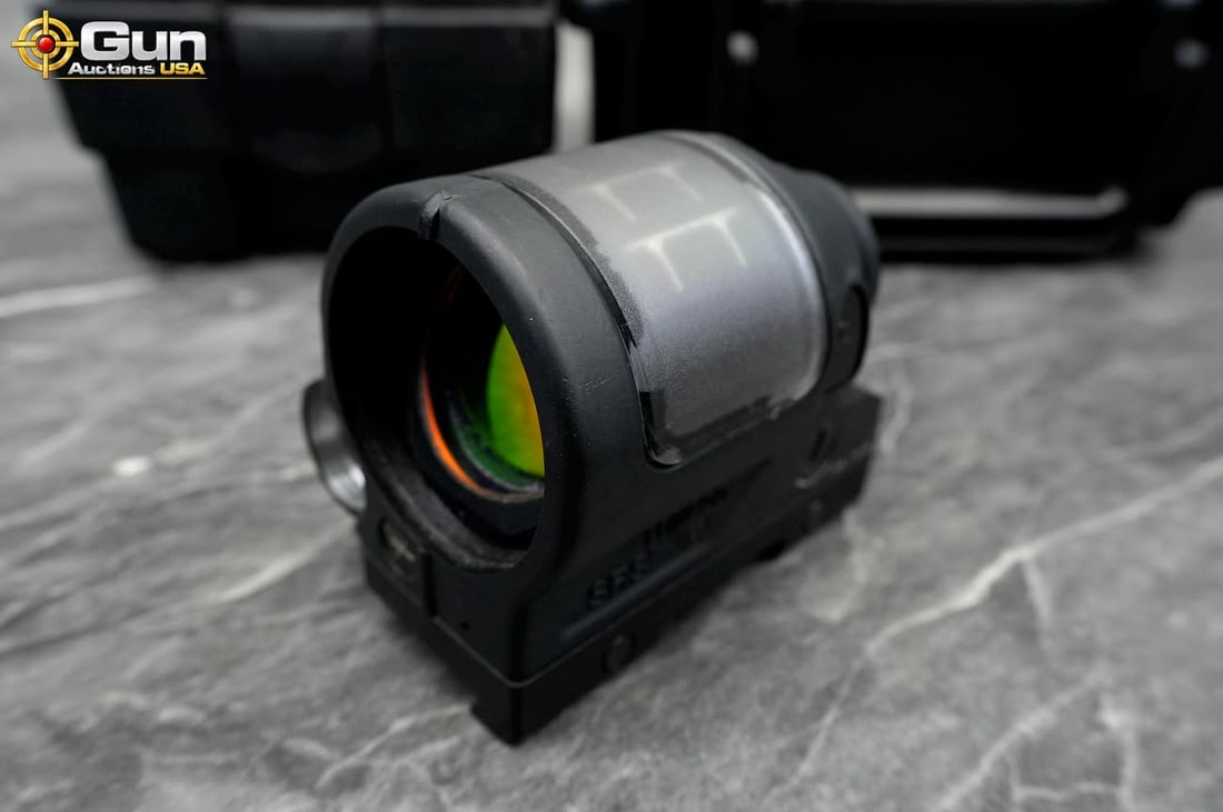 Trijicon SRS Reflex Sight with Hard Case, Needs Repair Condition This red dot optic features an: Trijicon SRS Reflex Sight with Hard Case, Needs Repair ConditionThis red dot optic features an integrated solar panel and a thumbscrew rail mount. It includes a protective hard-shell case with foam in