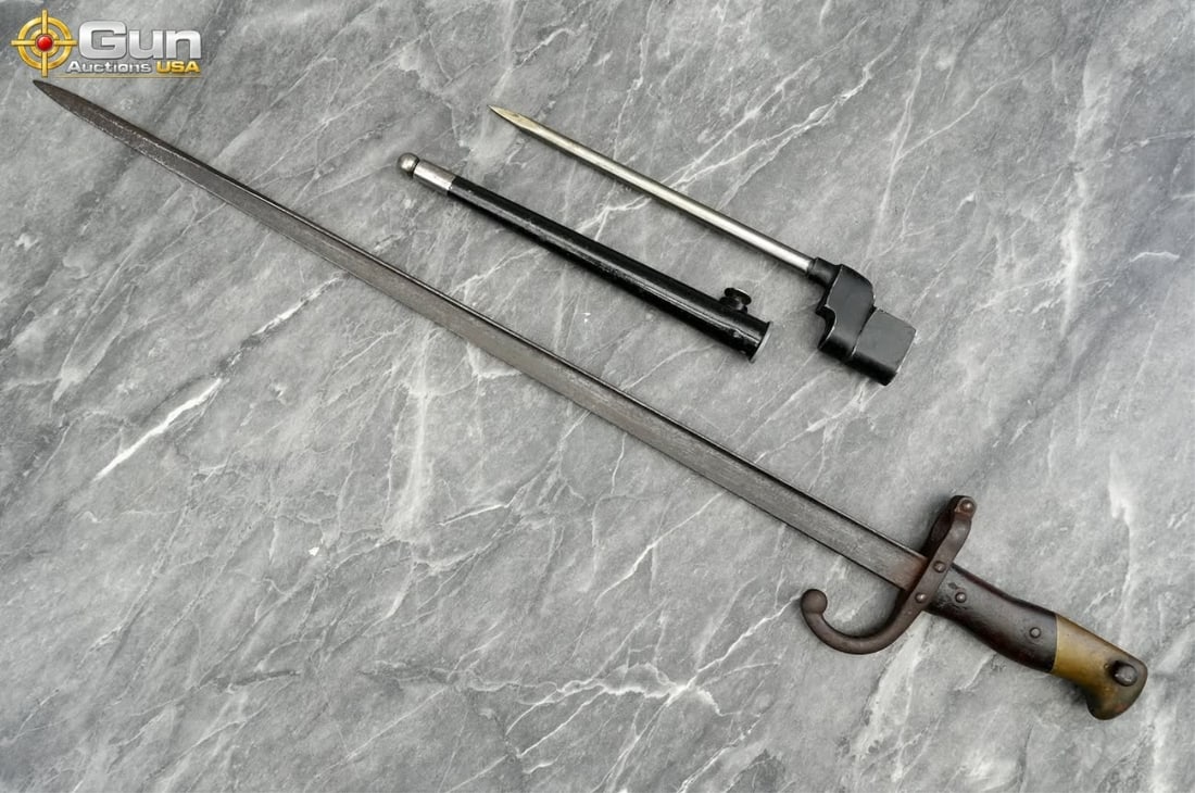Military bayonets, Fair Condition showing rust. It includes a French Model 1874 Gras sword bayonet: Military bayonets, Fair Condition showing rust. It includes a French Model 1874 Gras sword bayonet featuring T-section steel blade, wood handle scales, brass pommel, and curved quillon, along with a L