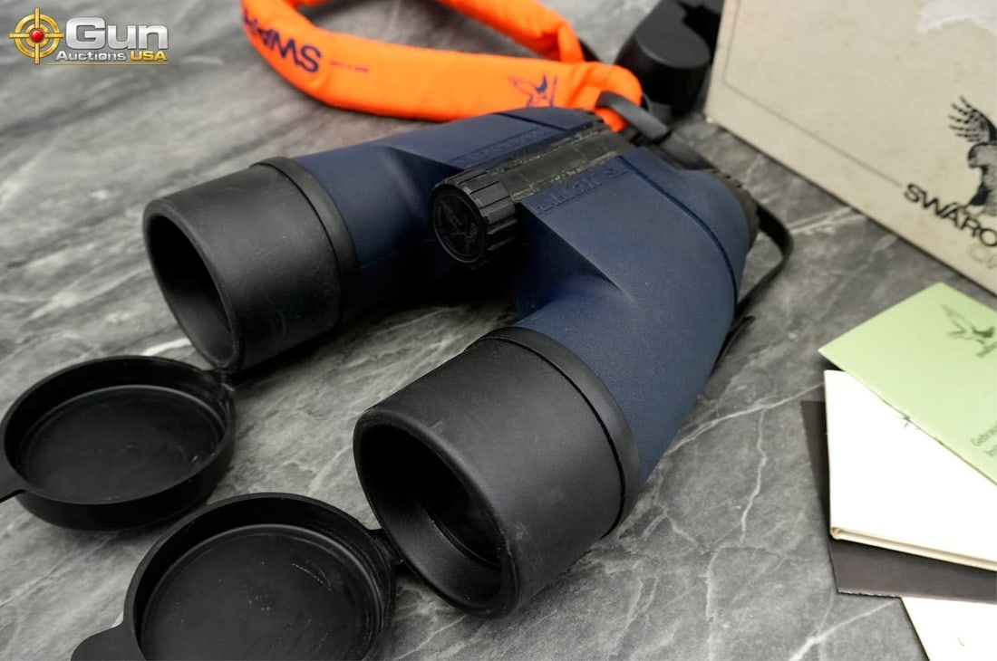 Swarovski Habicht SL binoculars, Very Good Condition These blue rubber-armored binoculars feature: Swarovski Habicht SL binoculars, Very Good ConditionThese blue rubber-armored binoculars feature integrated lens covers, central focus wheel, neck strap, lens cleaning cloth, and orange floating neck 