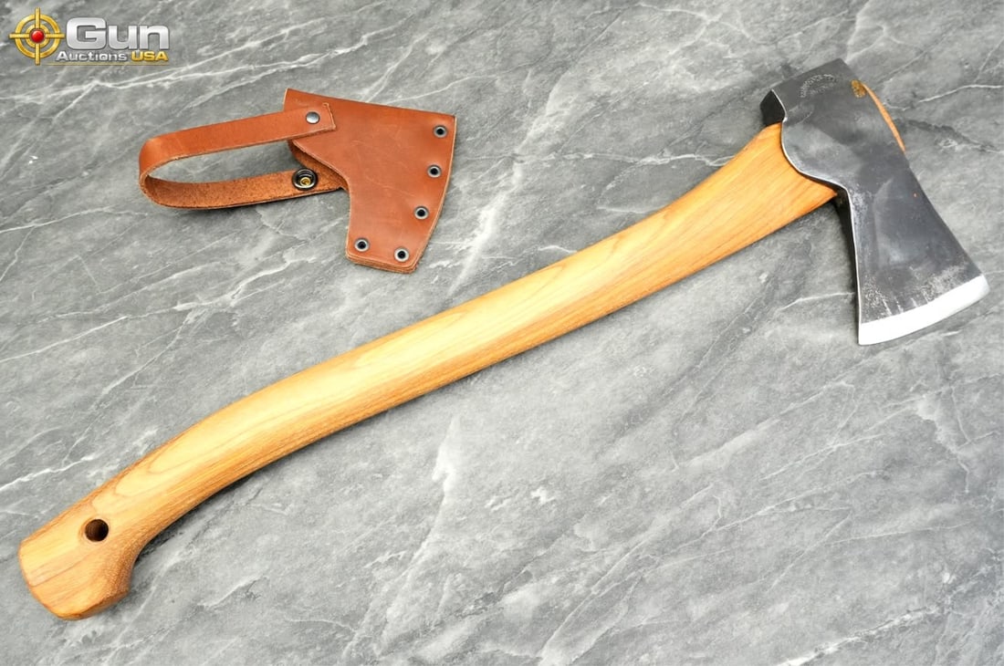 A single Gransfors Bruk axe, Excellent Condition Features a wood handle stamped with the: A single Gransfors Bruk axe, Excellent ConditionFeatures a wood handle stamped with the manufacturer's logo and includes a fitted brown leather blade cover. (500498) (GSCN22)