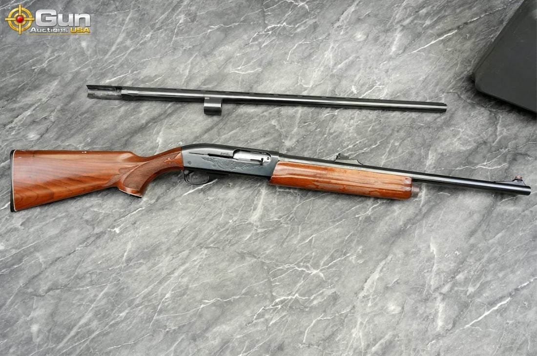 REMINGTON 1100 12 ga. Semi Auto Shotgun, 22" Barrel, Good Condition, Normal Handling Marks, Shiny: REMINGTON 1100 12 ga. Semi Auto Shotgun, 22" Barrel, Good Condition, Normal Handling Marks, Shiny Bore, Tight Action, sn:M013016V This 12-gauge features a blued receiver adorned with flowing scroll an