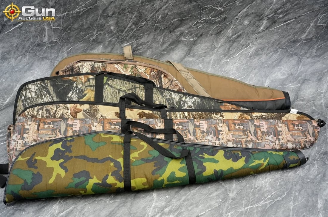 Five soft rifle cases. Good condition. 5 Soft ammo: Five soft rifle cases. Good condition.This lot includes five soft padded rifle cases in a variety of camouflage and solid finishes, each with a full-length zippered closure and carrying handles for tr