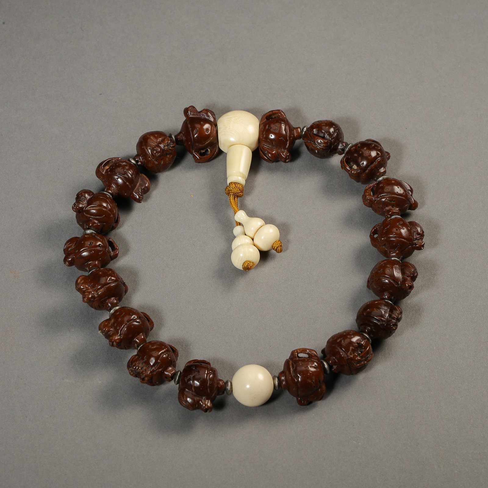 ANCIENT CHINESE BRACELETS WITH 18 OLIVE KERNEL BEADS: Diam. 1.9 cm. Weight 41 gram. In good condition, no restoration