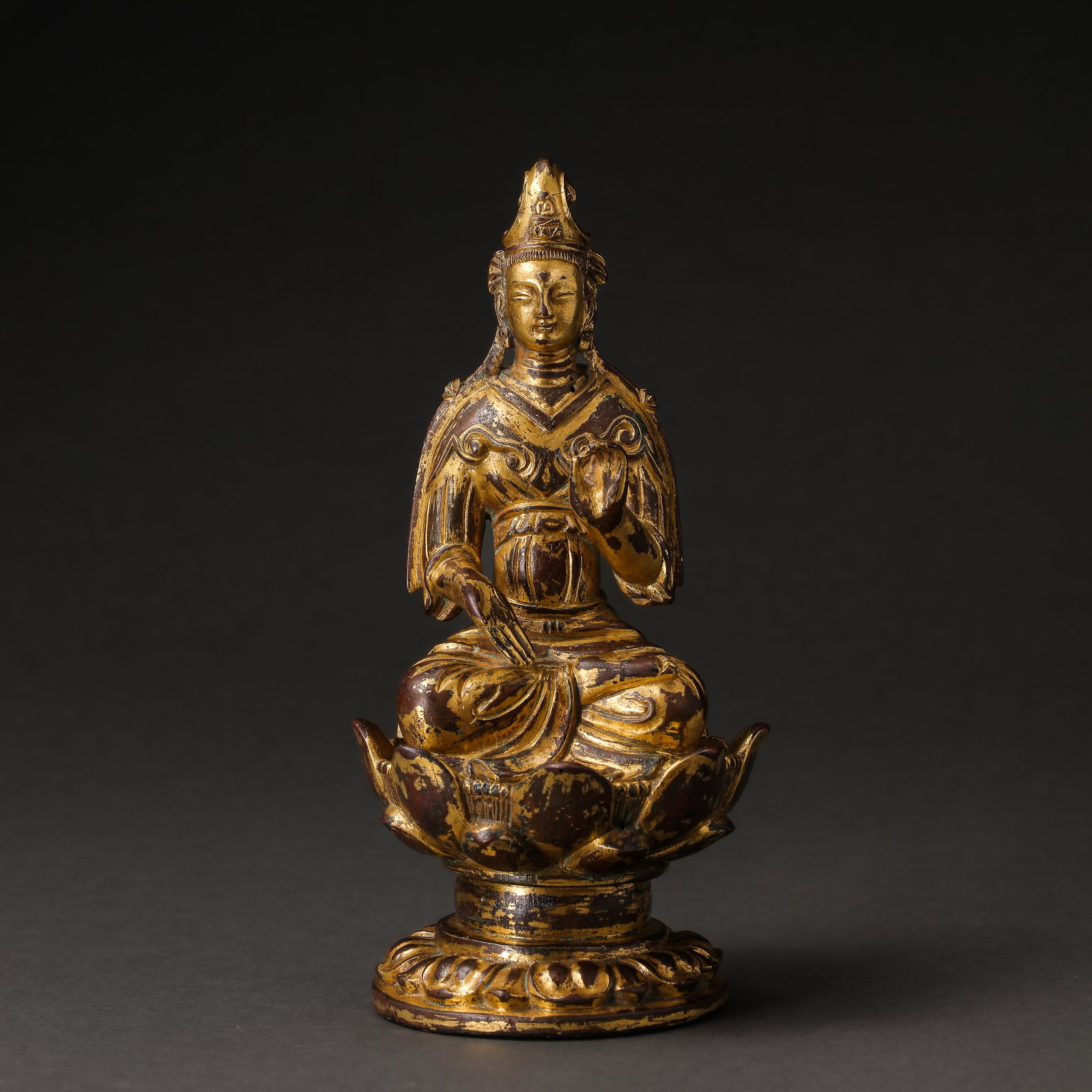 BEFORE THE MING DYNASTY, A GILT-BRONZE FIGURE OF A SEATED BUDDHA (1 of 7)
