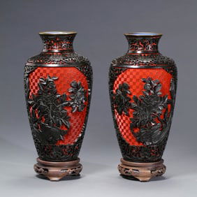 A pair of Chinese Qing Dynasty carved red flower patterned vases