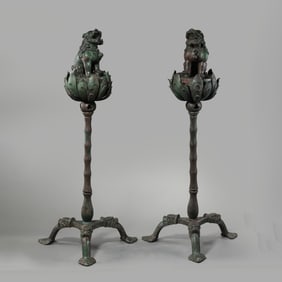 A pair of Chinese Liao Dynasty bronze lion-shaped incense burners