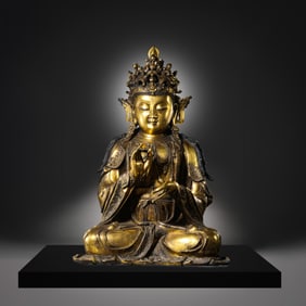 A Chinese Ming Dynasty gilt bronze statue of a seated Buddha