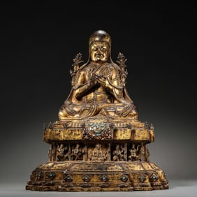 A Chinese Ming Dynasty gilt bronze statue of a seated Buddha