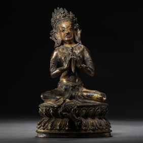 A Chinese Ming Dynasty gilt bronze statue of a seated Buddha