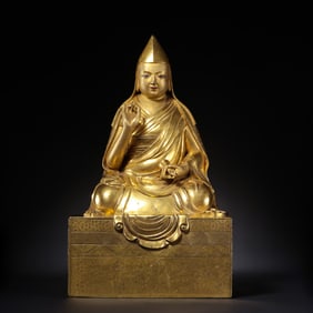 A Chinese Ming Dynasty gilt bronze statue of a seated Buddha