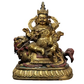 A gilt bronze seated statue of the God of Wealth from the Qianlong period of the Qing Dynasty in
