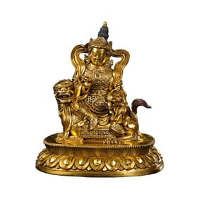 A gilt bronze seated statue of the God of Wealth from the Qing Dynasty of China.