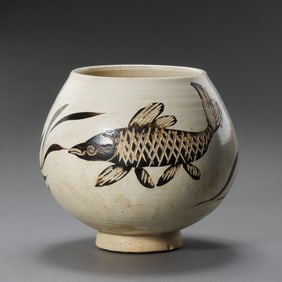 A white-glazed, black-decorated fish and seaweed patterned jar from the Cizhou kiln of the Northern