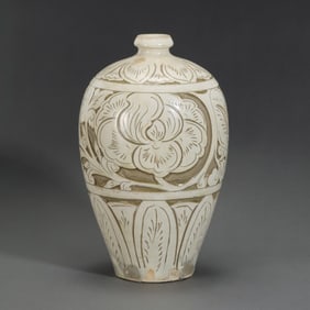 A white-glazed plum vase with carved floral patterns from the Cizhou kiln of the Northern Song