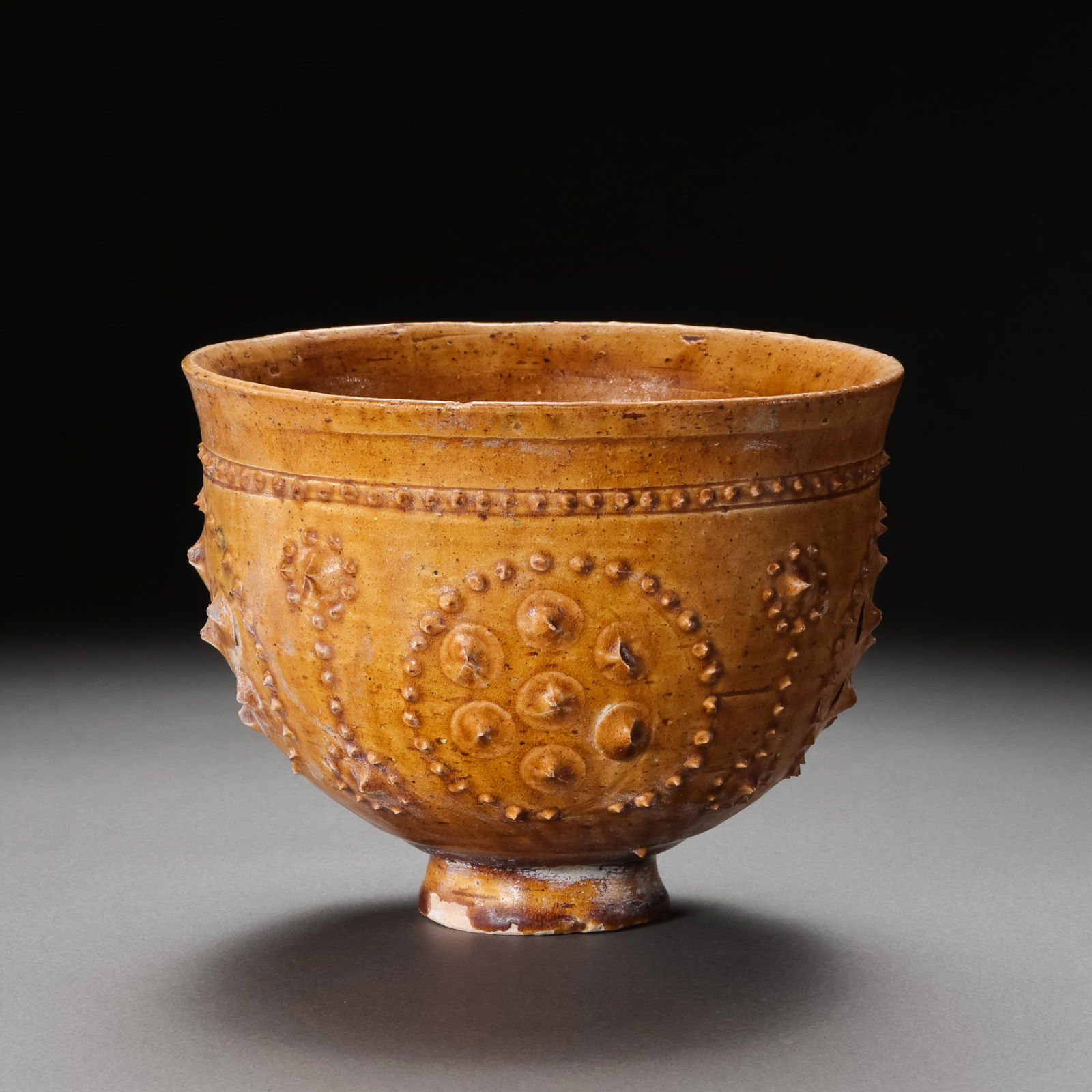 Yellow-glazed bowl with drum-nail pattern from the Sui Dynasty, China (1 of 10)