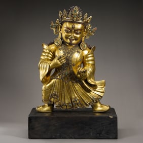 A standing bronze statue of the God of Wealth from the Ming Dynasty in China.