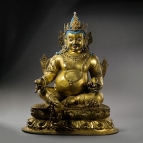 A gilt bronze seated statue of the God of Wealth from the Qing Dynasty of China.
