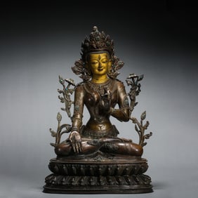 A Ming Dynasty Chinese bronze seated Buddha statue partially gilded and inlaid with turquoise.