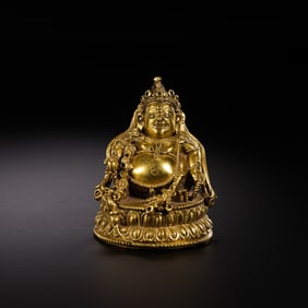 A gilt bronze seated statue of the God of Wealth from the Ming Dynasty of China.