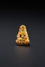 A pure gold seated statue of the God of Wealth from the Qing Dynasty in China