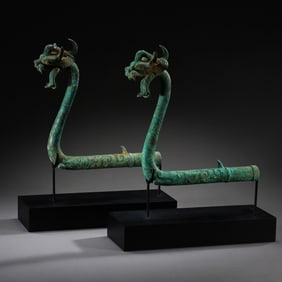 A pair of Chinese bronze dragon-head artifacts from the Shang and Zhou dynasties