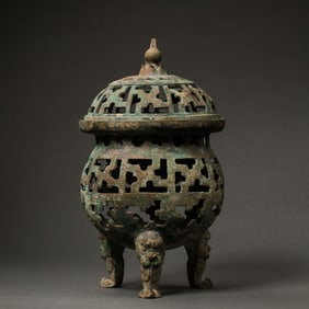 Openwork three-legged covered censer from the Warring States period of China