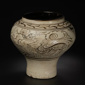 A white-glazed, black-decorated dragon and phoenix patterned jar from the Cizhou kiln of the