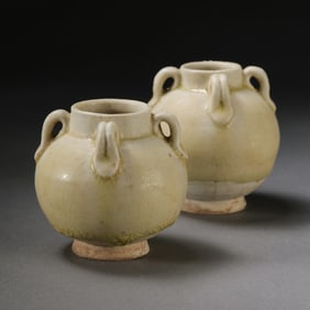 A pair of Chinese Sui Dynasty Xiangzhou kiln celadon four-handled jars